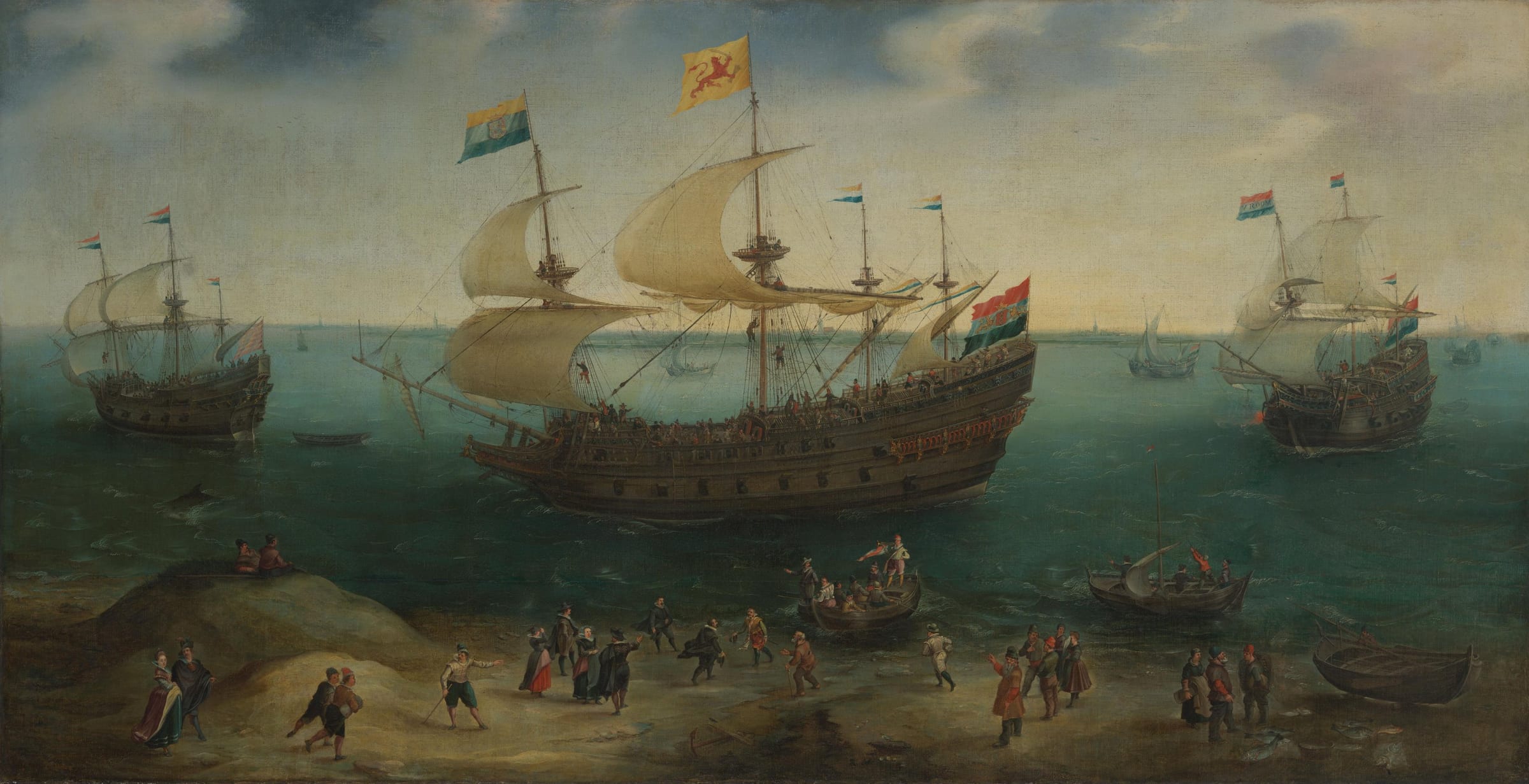 A large Dutch four-masted ship and its escorts under sail near a sandy shore, where townspeople gather to greet a boat coming in.